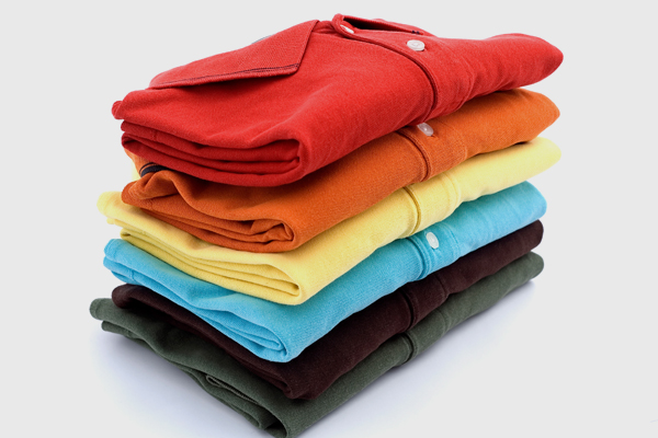 A stack of folded polo shirts.