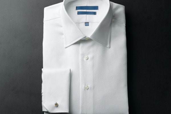 A man's pressed and folded white shirt