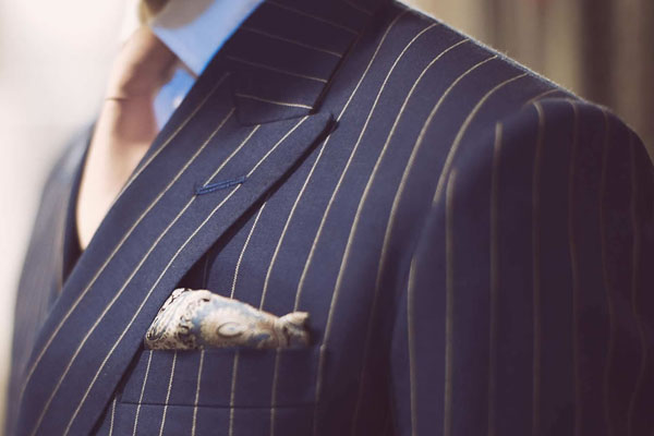 Man wearing a pin striped suit and tie.