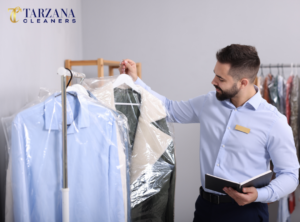 Professional dry cleaners in Encino inspecting freshly cleaned garments to ensure expert fabric care at Tarzana Cleaners